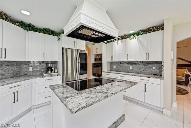 kitchen featuring light tile flooring, premium range hood, black appliances, tasteful backsplash, and white cabinetry