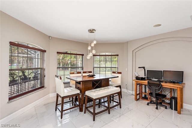 tiled dining room with a notable chandelier