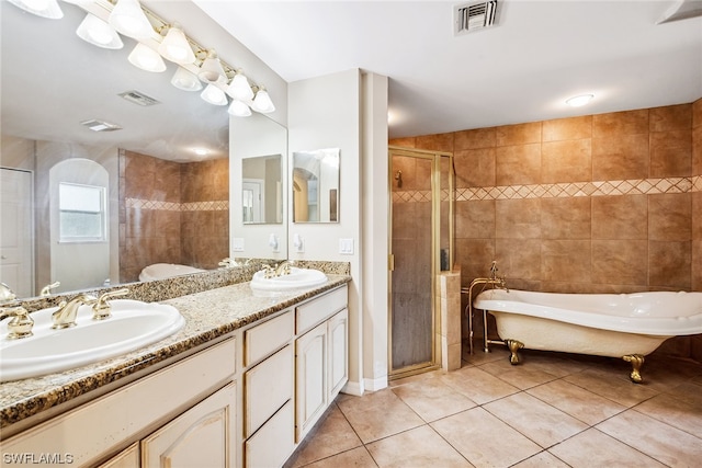 bathroom with tile flooring, double sink vanity, and shower with separate bathtub