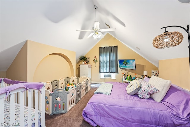 bedroom featuring lofted ceiling, dark carpet, and ceiling fan