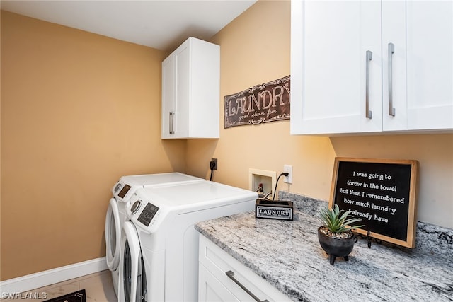 laundry room with light tile floors, washer and dryer, hookup for a washing machine, electric dryer hookup, and cabinets