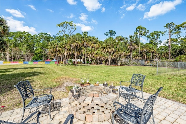 view of yard with a fire pit and a patio area