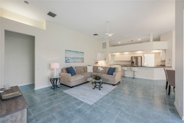 living room featuring tile patterned floors and ceiling fan