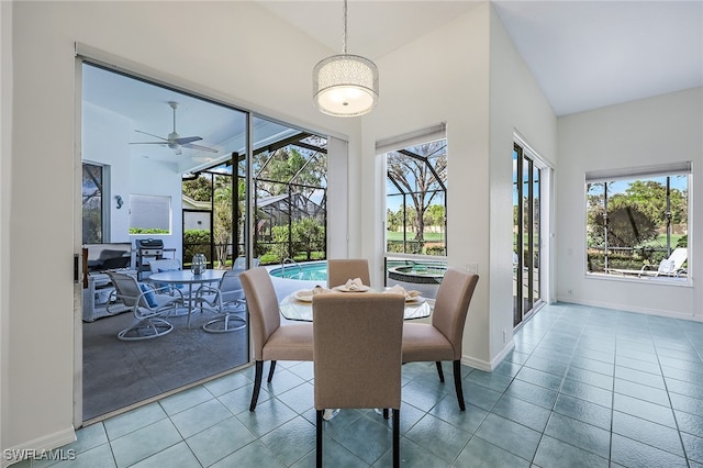 tiled dining room featuring ceiling fan and lofted ceiling