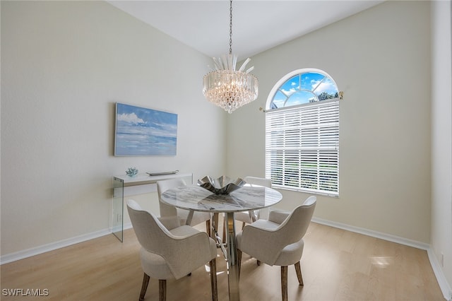 dining room with a chandelier and light wood-type flooring