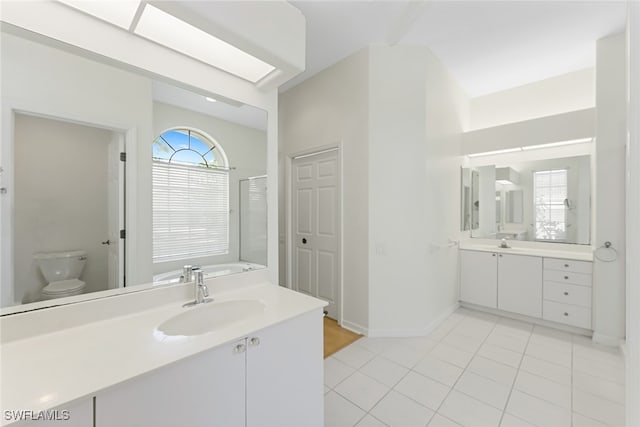 full bathroom featuring tile patterned floors, vanity, toilet, and shower with separate bathtub