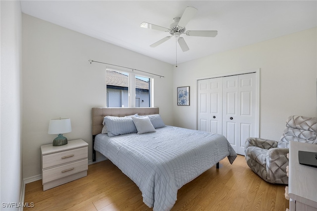 bedroom with ceiling fan, light wood-type flooring, and a closet