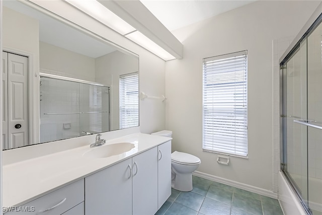 full bathroom featuring tile patterned floors, plenty of natural light, toilet, and vanity