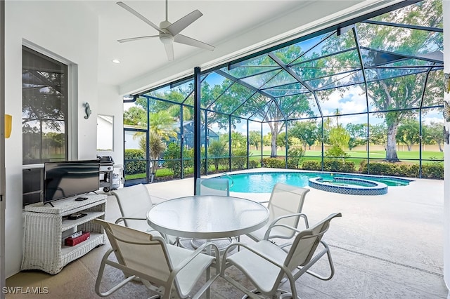 view of pool featuring a lanai, an in ground hot tub, ceiling fan, and a patio