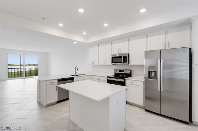 kitchen featuring a center island, appliances with stainless steel finishes, and white cabinetry