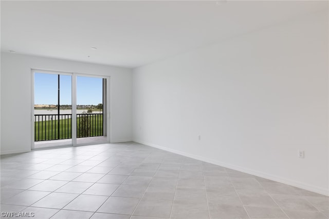 unfurnished room featuring light tile flooring