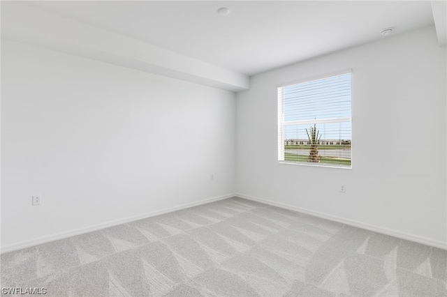 spare room featuring light colored carpet