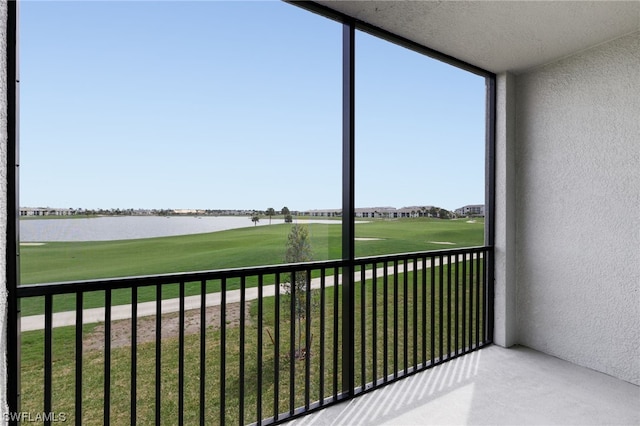 unfurnished sunroom with a water view