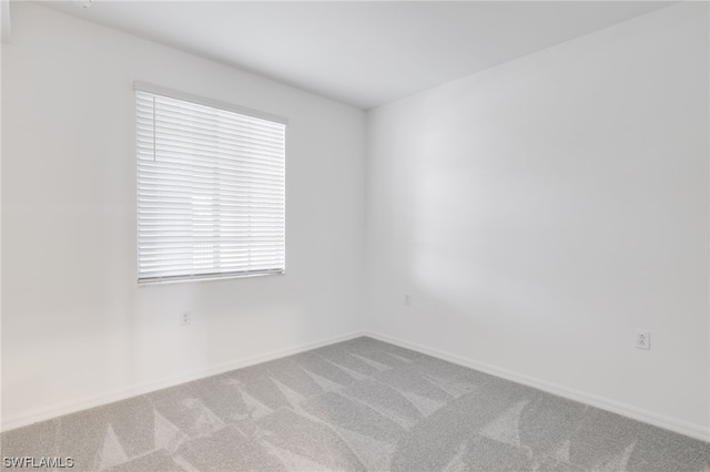 carpeted empty room with a healthy amount of sunlight