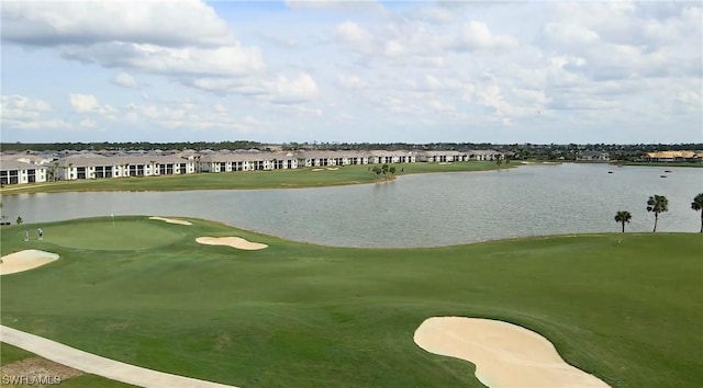 view of property's community with view of golf course, a water view, and a residential view
