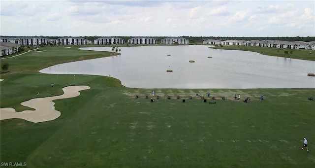 birds eye view of property featuring view of golf course and a water view