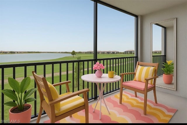 sunroom / solarium with a water view and golf course view