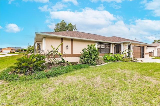 single story home featuring a front lawn and a garage