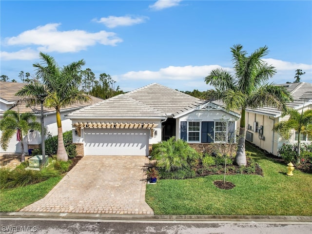 view of front of house featuring a garage and a front lawn