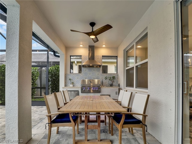 view of patio / terrace featuring ceiling fan, glass enclosure, and grilling area