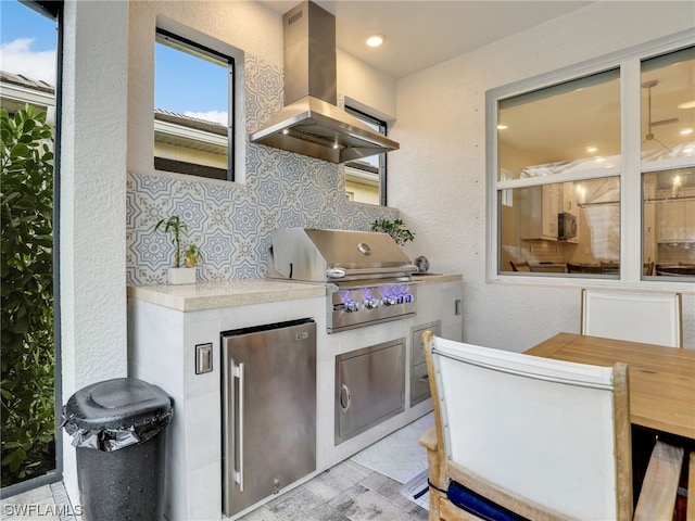 view of patio / terrace with an outdoor kitchen and a grill