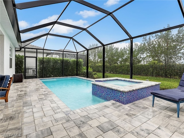 view of swimming pool featuring glass enclosure, an in ground hot tub, and a patio area