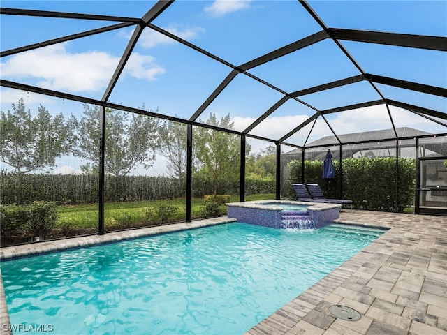 view of swimming pool with pool water feature, glass enclosure, an in ground hot tub, and a patio