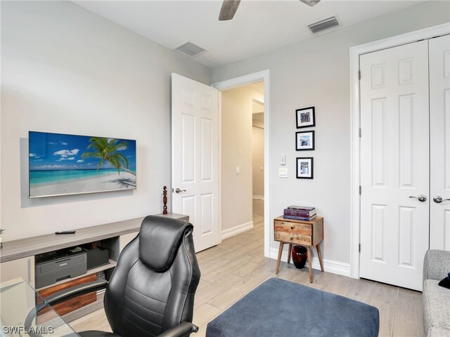 office space featuring ceiling fan and light hardwood / wood-style flooring