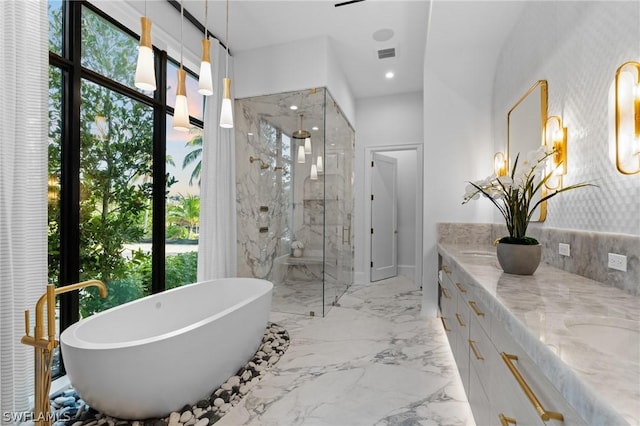 bathroom with vanity and independent shower and bath