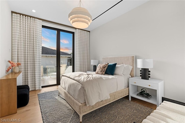 bedroom with light wood-type flooring and access to outside