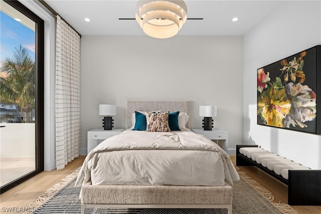 bedroom with access to exterior, ceiling fan, and light hardwood / wood-style flooring