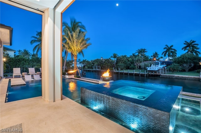 view of pool featuring a patio area, an in ground hot tub, and pool water feature