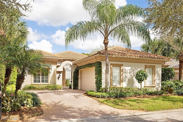 mediterranean / spanish-style home with a garage