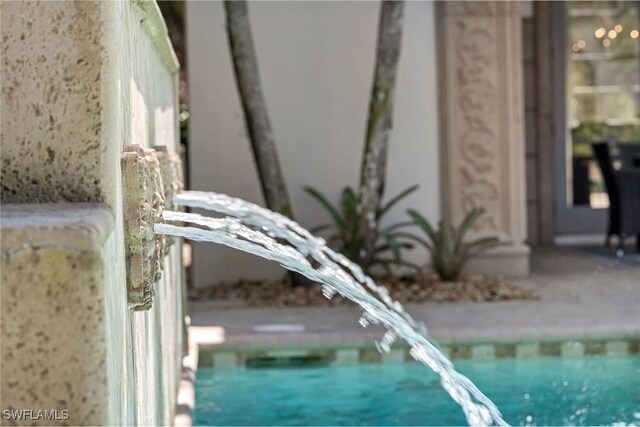 exterior details with a swimming pool