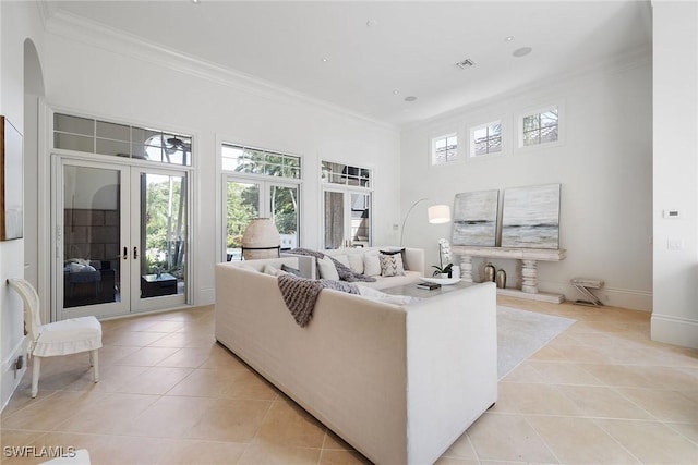 living room featuring light tile patterned flooring, ornamental molding, and french doors