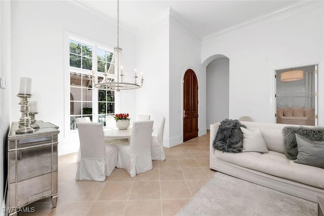 tiled dining room featuring a chandelier and crown molding