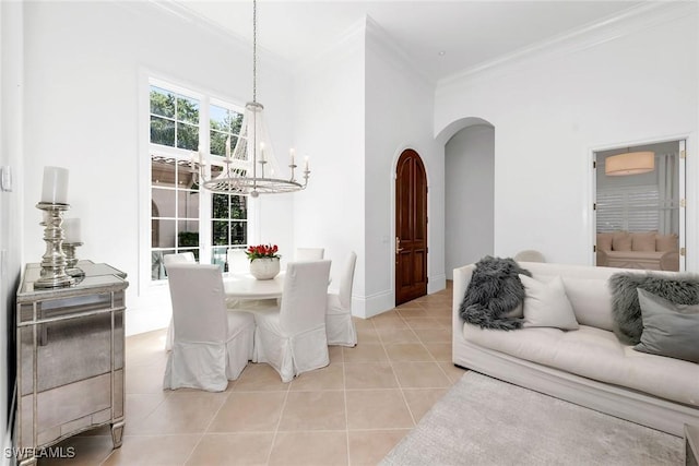 tiled dining area with ornamental molding and a chandelier