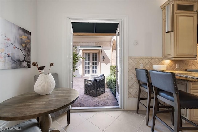 doorway to outside featuring light tile patterned flooring