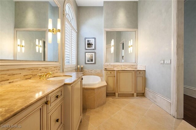 bathroom featuring tile patterned floors, vanity, and a relaxing tiled tub