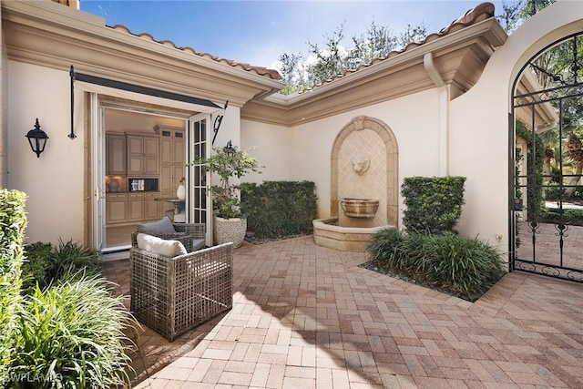 entrance to property with a patio