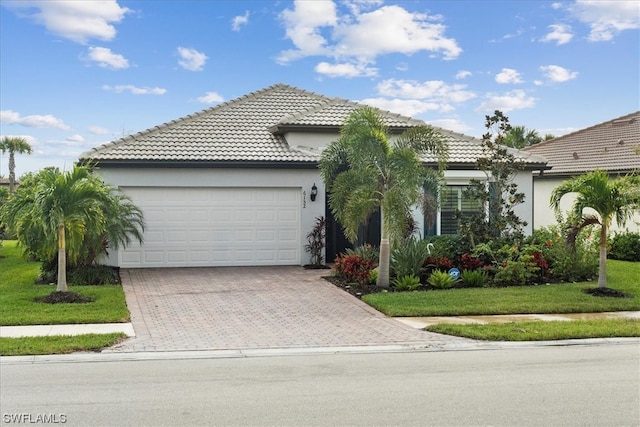 view of front of property with a front lawn and a garage