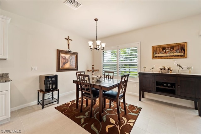 tiled dining area featuring a notable chandelier