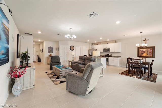 living room with light tile floors and a chandelier