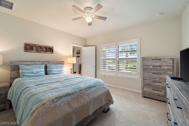 bedroom featuring light colored carpet and ceiling fan