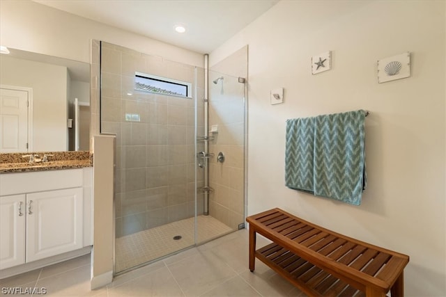 bathroom featuring tile floors, walk in shower, and oversized vanity