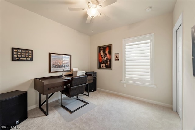 carpeted office featuring ceiling fan