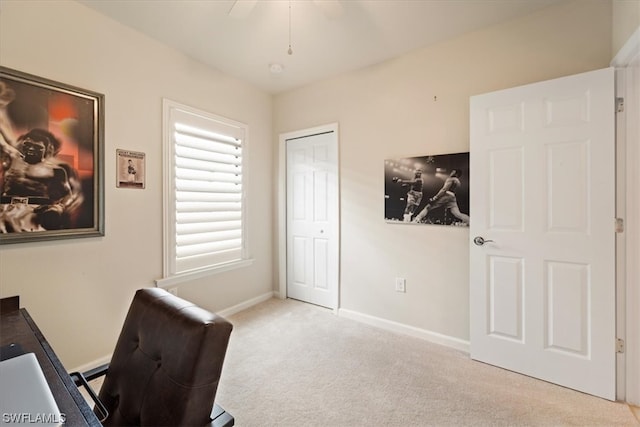 home office featuring light carpet and ceiling fan