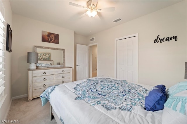 bedroom featuring a closet, light carpet, and ceiling fan