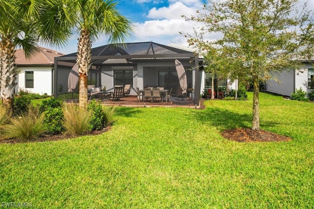 back of property featuring a lawn, a patio area, and a lanai