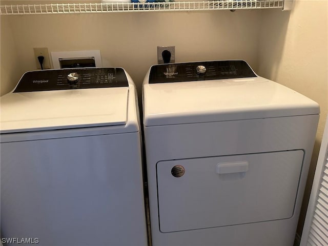 clothes washing area featuring separate washer and dryer